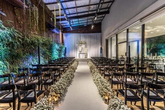 Decorated wedding venue aisle lined with white florals